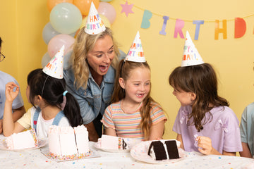 Kids celebrating a birthday party in the party room at Power Play Sydney with cake, balloons and colourful decorations.