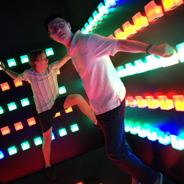 Group enjoying interactive light wall experience at Power Play Sydney venue