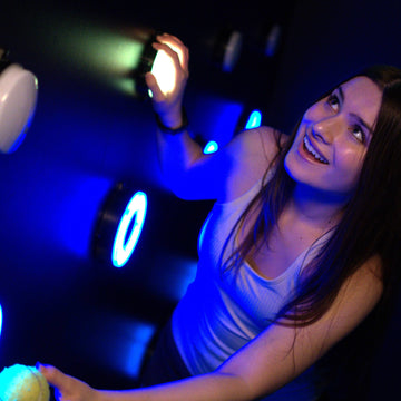 Close up of player interacting with pipe game light wall at Power Play Sydney venue